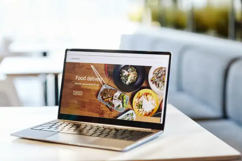 A laptop displaying a website maintenance menu on a table.