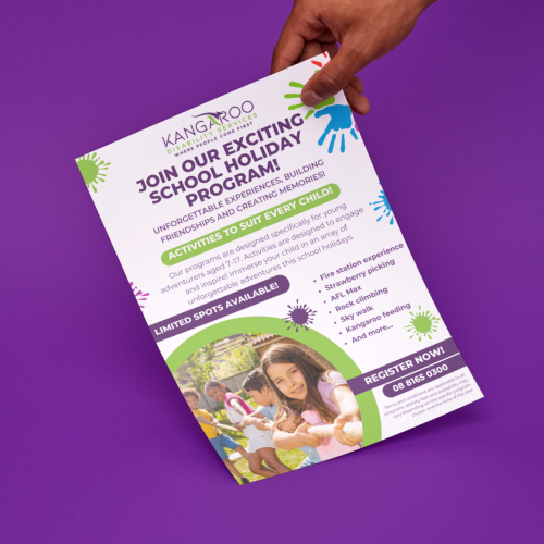 A hand holds a colorful flyer promoting a school holiday program by Kangaroo Land Adventure. The flyer highlights various activities for children, with a "Limited Spots Available" note and contact details.