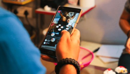 A person holding a cell phone with a picture on it.